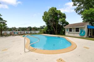 a large swimming pool with a metal rail around it at Luxury Waterfront Pool House 7 mins to TIAA Bank Field in Jacksonville