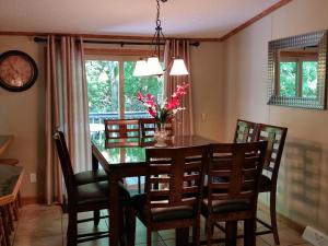 a dining room with a wooden table and chairs at Island Club Rentals in Put-in-Bay