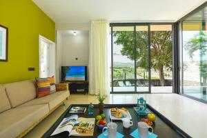 a living room with a couch and a table at GreenSide 40 by VillaGranCanaria in Maspalomas