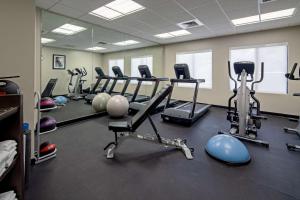 a gym with several tread machines and exercise bikes at Best Western Valencia/Six Flags Inn & Suites in Santa Clarita