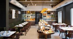 a restaurant with tables and chairs and a buffet at Bat Sheva Jerusalem by Jacob Hotels in Jerusalem