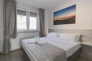 a bedroom with a bed with a swan on it at Villa Boutique Tenerife in Adeje