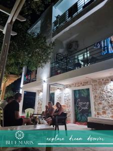 a group of people sitting outside of a building at Blue Maris in Sutomore