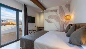 a bedroom with a bed and a large window at DWO Nopal in Puerto de la Cruz