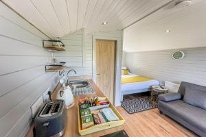 a small room with a couch and a bed at Riabhach in Fort William