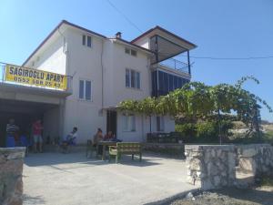 a group of people sitting outside of a building at Salda Lake Sagiroglu Apart in Gökçe