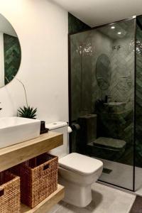 a bathroom with a toilet and a shower and a sink at Casa Mariel in Málaga