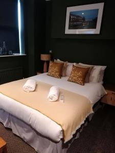 a hotel room with a large bed and a large window at Old Ship Inn Hackney in London