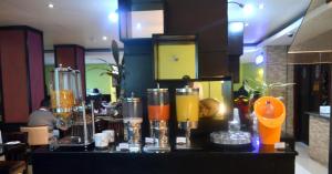 a bar in a restaurant with some drinks on it at Best Western Premier Accra Airport Hotel in Accra