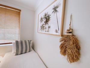 a white room with a couch and a window at Villa 5 Whitesands in Dunsborough