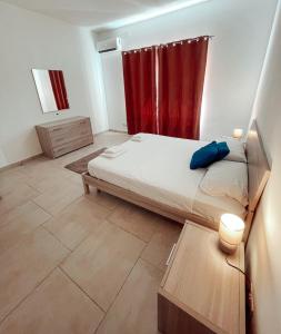 a bedroom with a bed and a red curtain at Central Modern Apartment in Il-Gżira