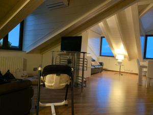 a living room with a tv in the attic at Arona Prestige Apartments in Arona