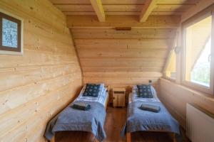 Posteľ alebo postele v izbe v ubytovaní Domek Góralski Modrzewiowa Weranda