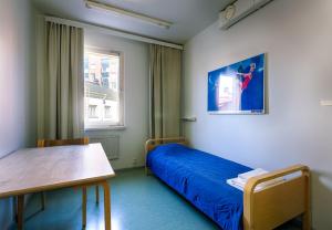 a room with a bed and a table and a window at Eurohostel in Helsinki