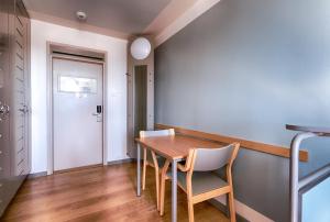 a dining room with a wooden table and chairs at Eurohostel in Helsinki