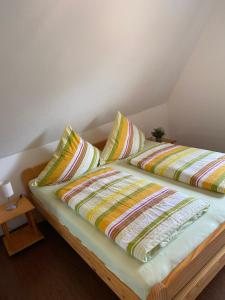 a bed with two pillows on top of it at Wohnung auf dem Lande in Riepsdorf