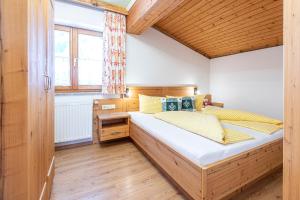a bedroom with a large wooden bed in a room at Moarbauer in Dorfgastein