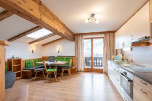a kitchen with a table and a dining room at Moarbauer in Dorfgastein