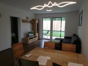 uma sala de estar com um sofá e uma mesa em Ferienbungalows Vital em Lanzenkirchen