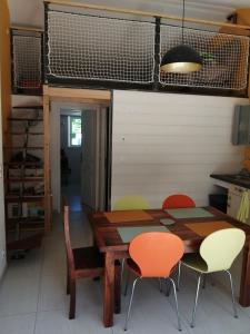 a dining room with a wooden table and chairs at Maison à la campagne in Lyaud