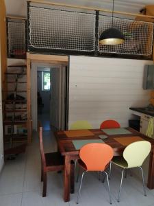 a dining room with a wooden table and chairs at Maison à la campagne in Lyaud +4 photos