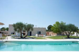 una piscina di fronte a una casa alberata di Dimora Maria Charming Home a Lamie di Olimpia