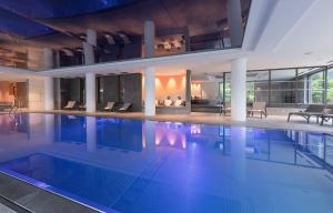 a large swimming pool in a building at Rivage Hôtel & Spa Annecy in Annecy