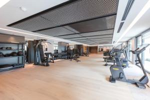 a gym with treadmills and elliptical machines at Rivage Hôtel & Spa Annecy in Annecy