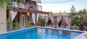 uma piscina com duas cadeiras e uma casa em Galazio Asteri I em Loutrópolis Thermís