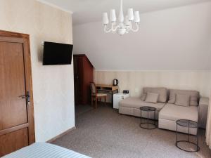 a living room with a couch and a table at Kavaler inn hotel in Kuty