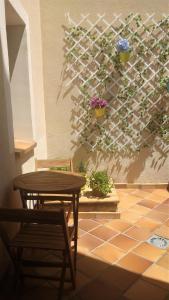 a table and chairs in a room with plants at Casa Siete Picos in Torrecaballeros