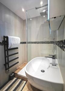 a bathroom with a white sink and a shower at Apartment in the heart of East Wittering Village in Chichester