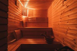 una sauna de madera con un cubo dentro en SOVIA WELLNESS CHATA s jacuzzi kaďou a saunou, Čingov, en Smižany