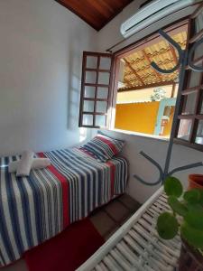 a bedroom with a bed and a window at VILLA COIMBRA in Lauro de Freitas