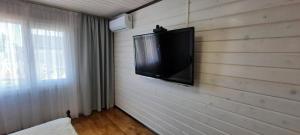 a flat screen tv mounted on a wall at Новый дом целиком 800м от моря за городом в тихом уютном месте in Chornomorsk