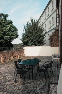 a table and chairs sitting on a brick patio at Apartments in the historic part of Znojmo in Znojmo