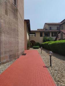 a red brick walkway in front of a building at Battisti in Pavia