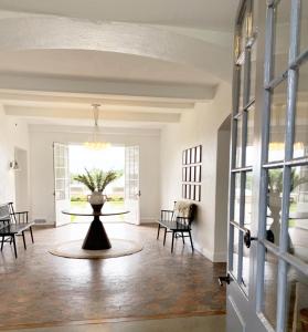 a hallway with a table with a vase on it at Shepherd’s Run in South Kingstown