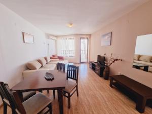 a living room with a couch and a table at Top Complex in Sveti Vlas