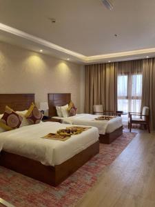 Katil atau katil-katil dalam bilik di Alsahwa Hotel