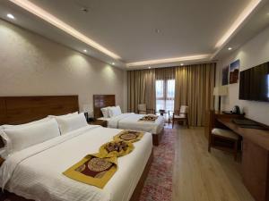 Katil atau katil-katil dalam bilik di Alsahwa Hotel