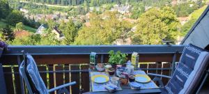 a table with plates of food on a balcony at Zum Schwalbennest in Todtmoos