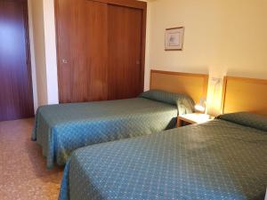 a hotel room with two beds in a room at Mariscal 5-Fincas Benidorm in Benidorm