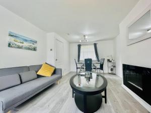 a living room with a couch and a table at Central Hamilton House in Hamilton