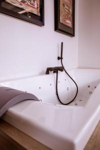 a white bed with a lamp on top of it at App'Art - Le R in Kaysersberg