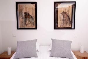 a bedroom with two mirrors and a bed with two pillows at App'Art - Le R in Kaysersberg +18 photos