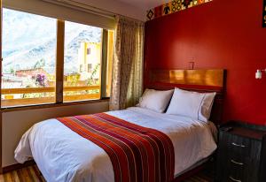 A bed or beds in a room at Hotel Tierra Inka Sacred Valley