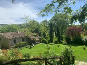 a view of a garden with a house at Campagna House in Casole dʼElsa