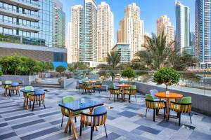 a patio with tables and chairs and buildings at Crowne Plaza Dubai Marina, an IHG Hotel in Dubai