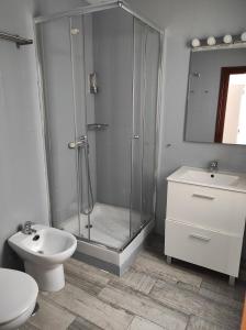 a bathroom with a shower and a toilet and a sink at Apartamentos CENTRO HISTORICO in Málaga +9 photos